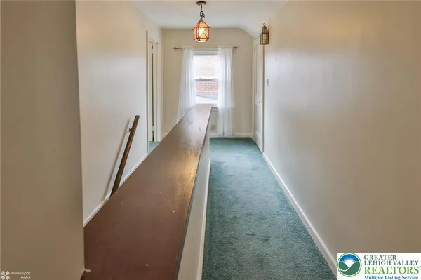 view of a hallway with wooden floor and staircase