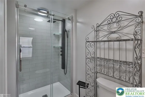 a bathroom with a shower and a sink