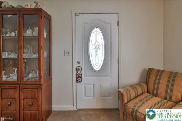 a living room with furniture a mirror and a window