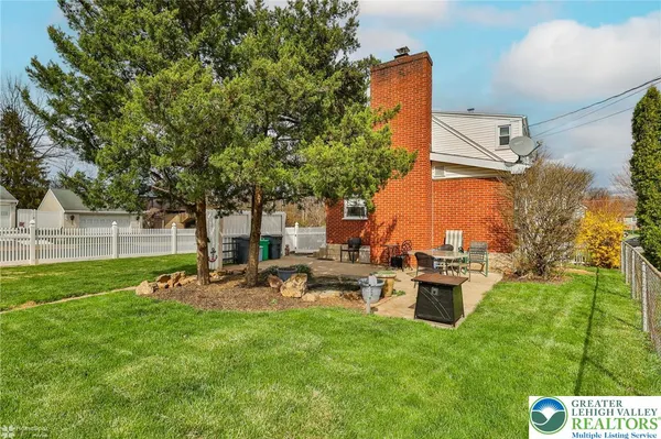 a view of a backyard with sitting area