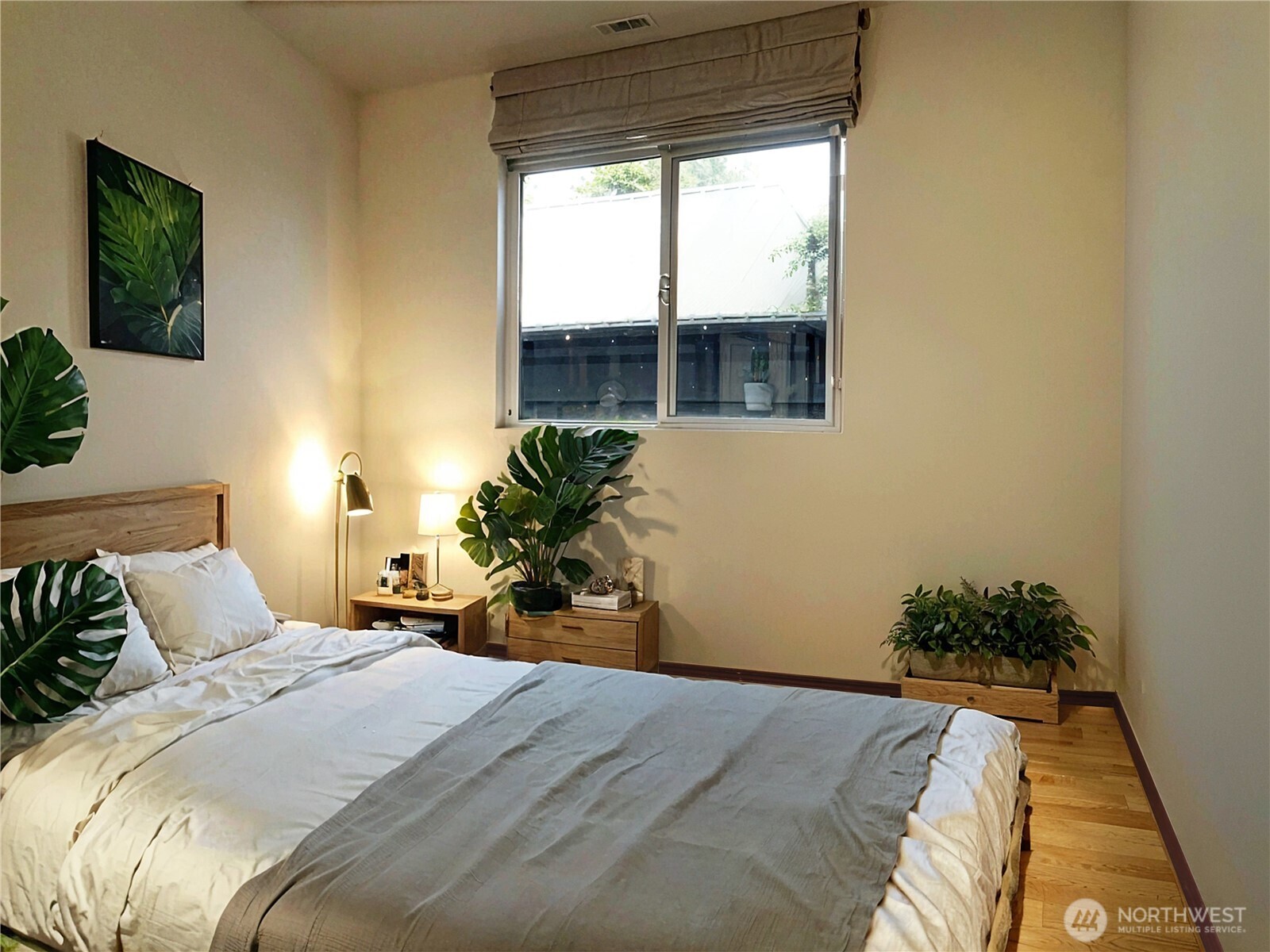 5451 32nd Avenue Southwest Seattle, WA 98126 - Photo 11 of 34 a bedroom with a bed and a potted plant