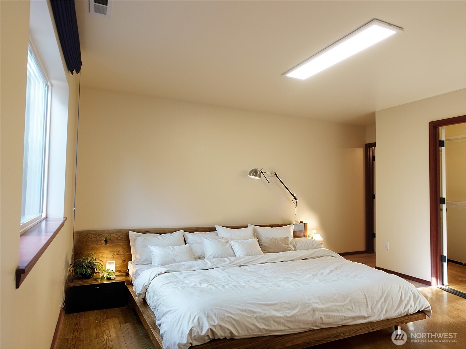 5451 32nd Avenue Southwest Seattle, WA 98126 - Photo 13 of 34 a bedroom with a bed and a flat tv screen on dresser