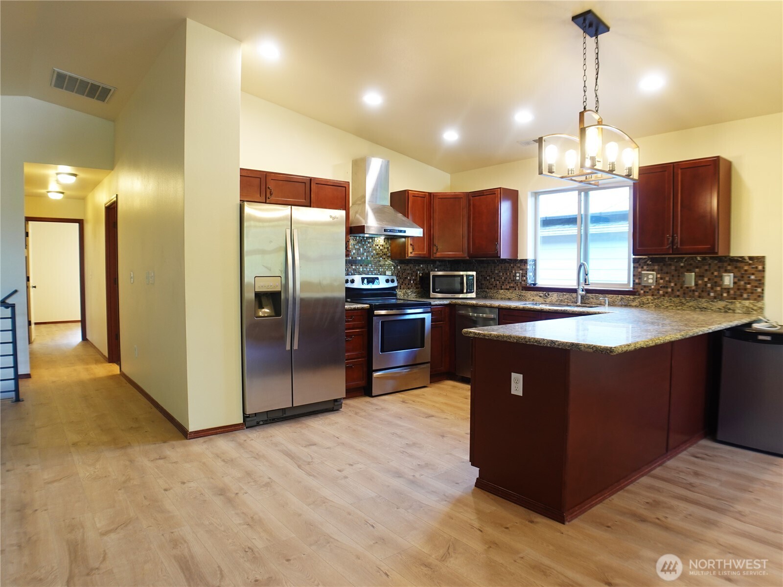 5451 32nd Avenue Southwest Seattle, WA 98126 - Photo 21 of 34 a kitchen with stainless steel appliances granite countertop a stove a refrigerator and a sink