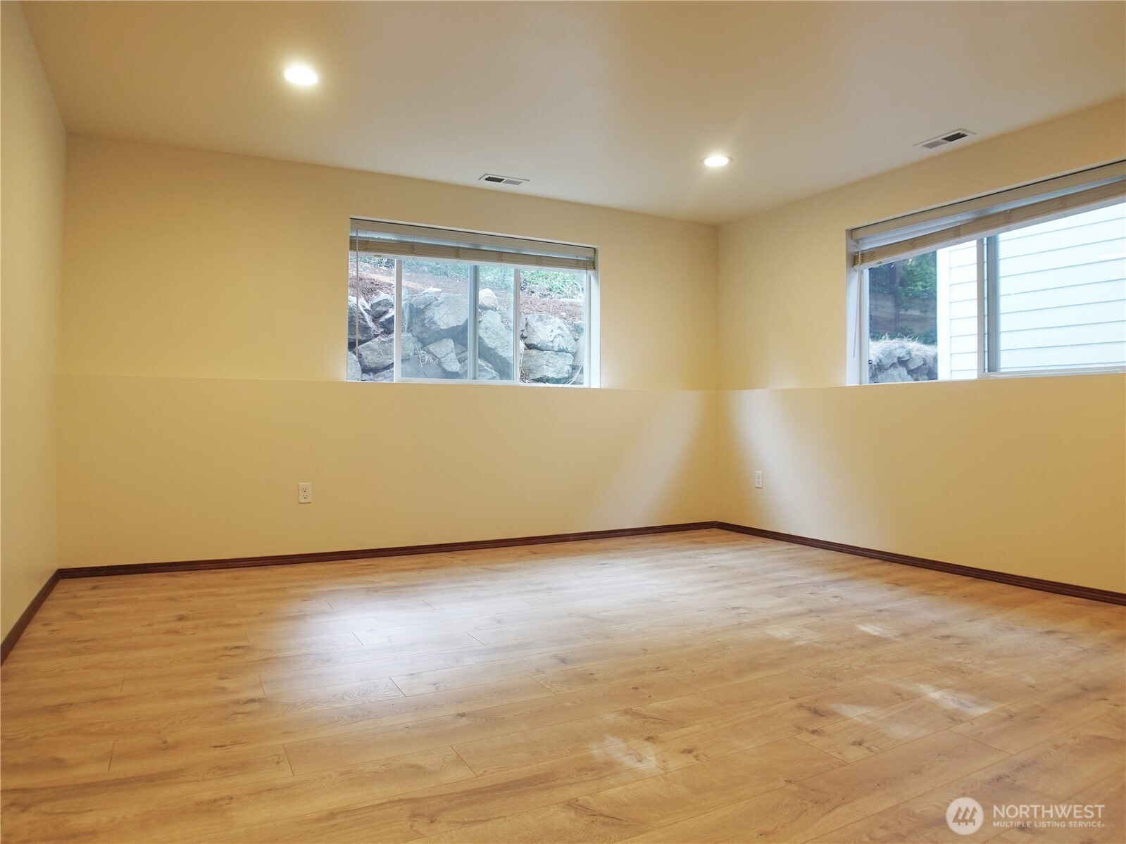 5451 32nd Avenue Southwest Seattle, WA 98126 - Photo 25 of 34 an empty room with wooden floor and windows