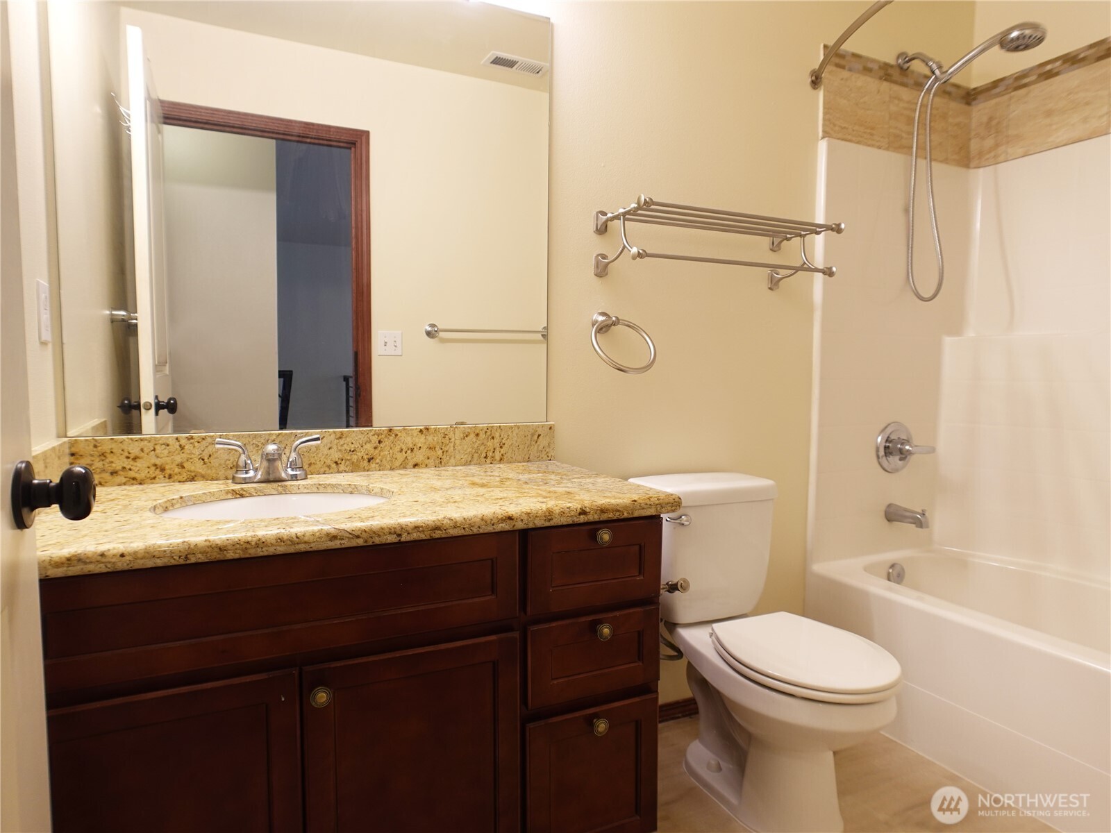 5451 32nd Avenue Southwest Seattle, WA 98126 - Photo 6 of 34 a bathroom with a granite countertop sink toilet mirror and shower