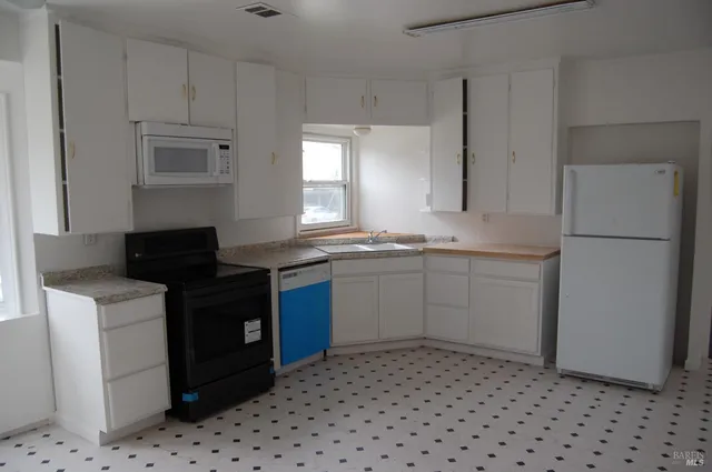 a kitchen with a sink a stove and refrigerator