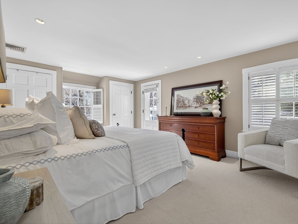 5 Tennyson Road Wellesley, MA 02481 - Photo 17 of 28 a bedroom with a bed and dresser with mirror