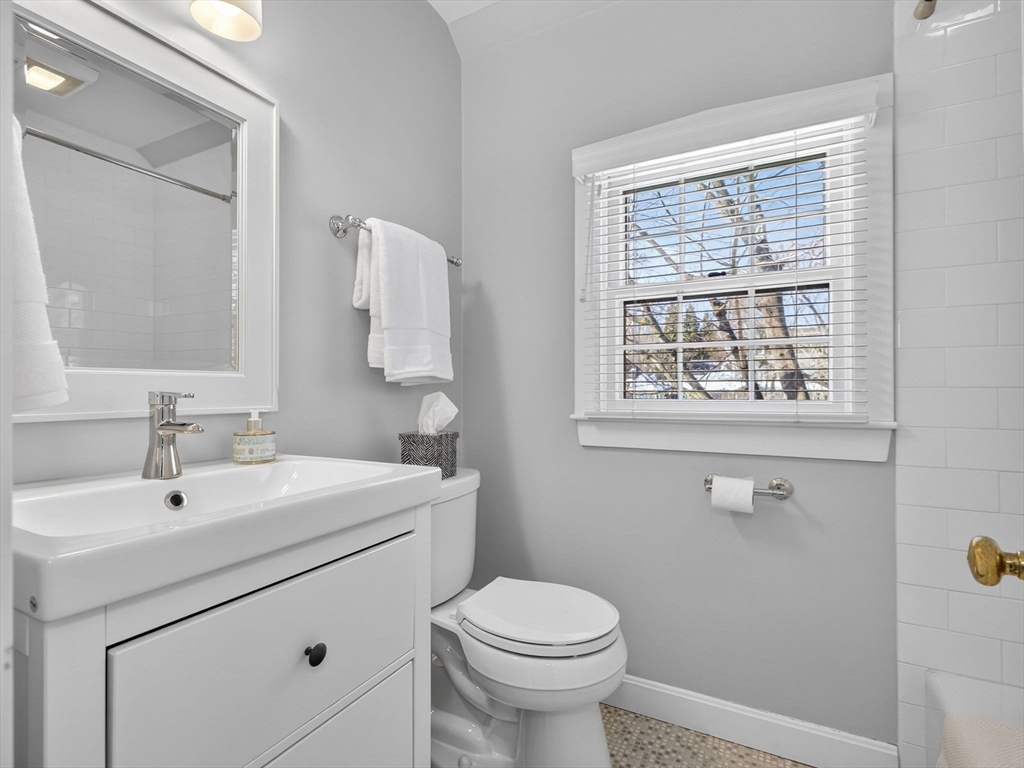 5 Tennyson Road Wellesley, MA 02481 - Photo 22 of 28 a bathroom with a toilet sink and mirror