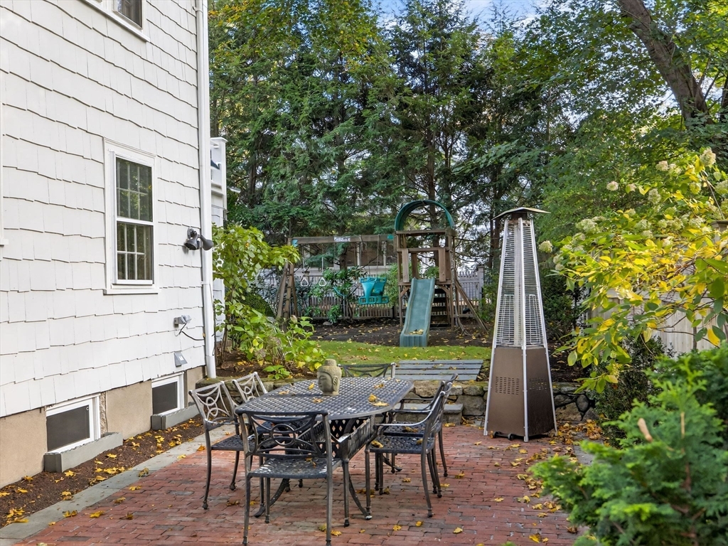 5 Tennyson Road Wellesley, MA 02481 - Photo 26 of 28 a backyard of a house with table and chairs