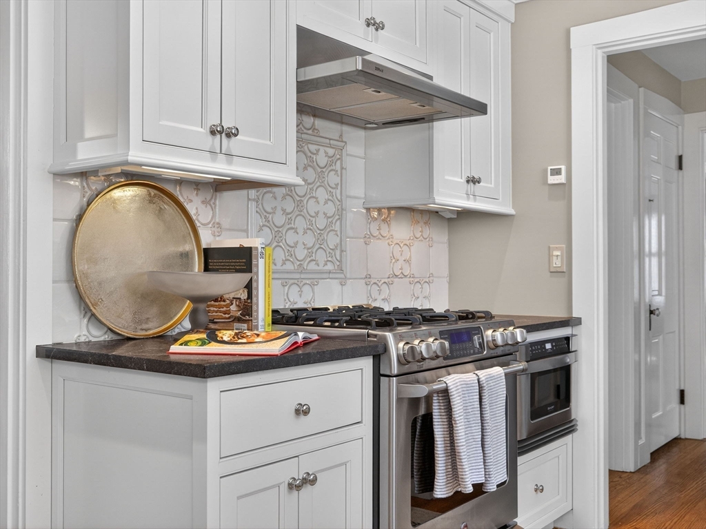 5 Tennyson Road Wellesley, MA 02481 - Photo 9 of 28 a kitchen with white cabinets and a stove