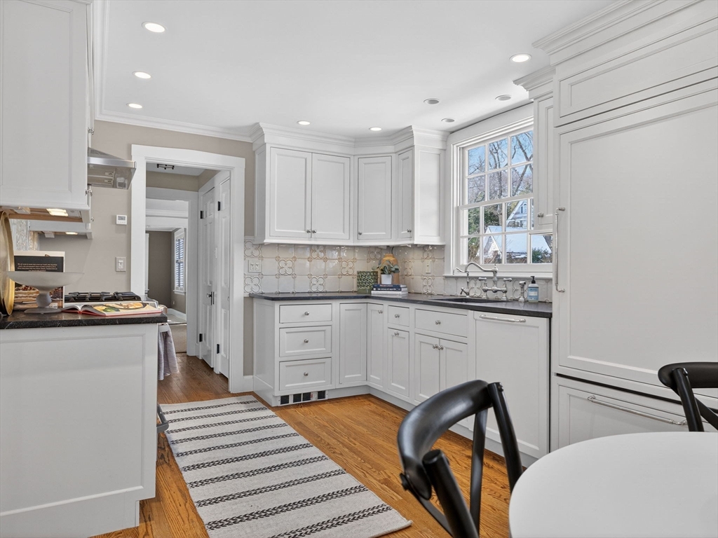 5 Tennyson Road Wellesley, MA 02481 - Photo 10 of 28 a kitchen with a sink stove and white cabinets