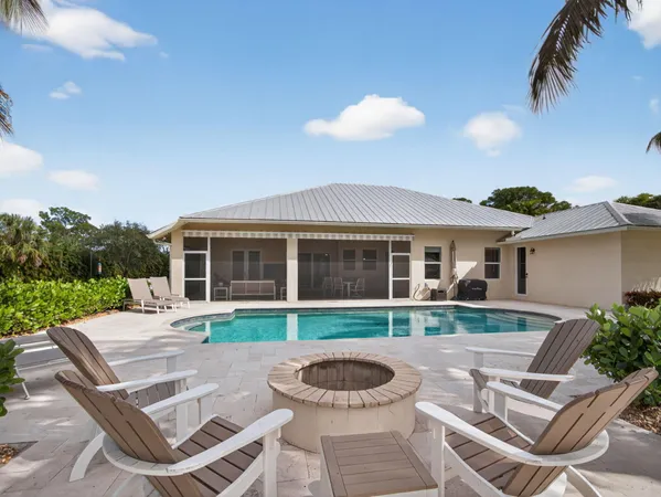a view of a house with a yard and furniture