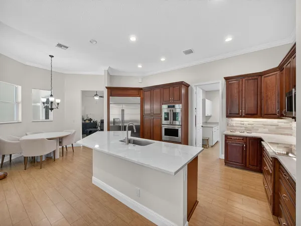 a large kitchen with stainless steel appliances lots of counter space and breakfast area