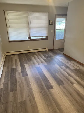 a view of room with window and wooden floor