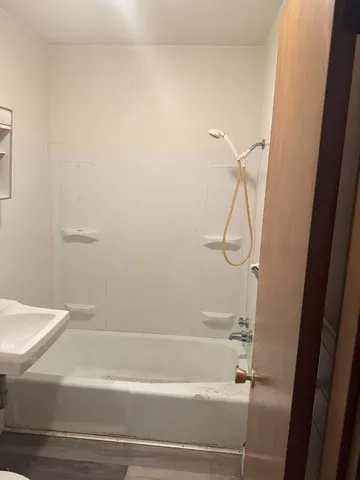 a bathroom with a shower and a bath tub