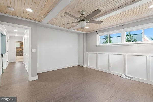 wooden floor in an empty room with a window