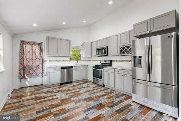 a kitchen with a refrigerator and a sink