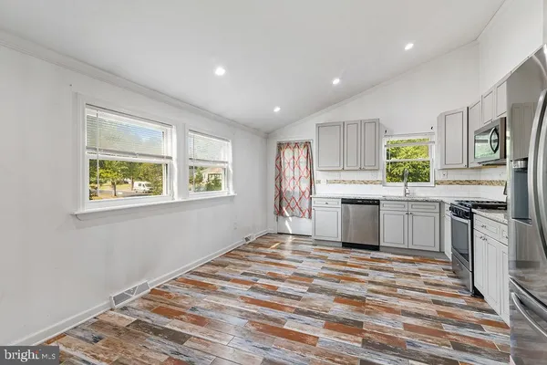 a kitchen with stainless steel appliances granite countertop a stove and a refrigerator