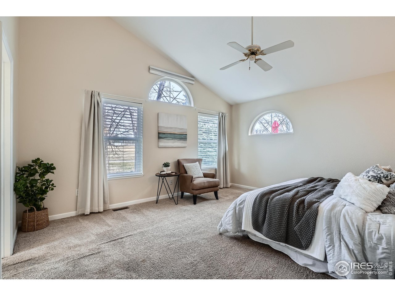 7051 Johnson Circle Niwot, CO 80503 - Photo 14 of 34 a bedroom with a bed and a chandelier