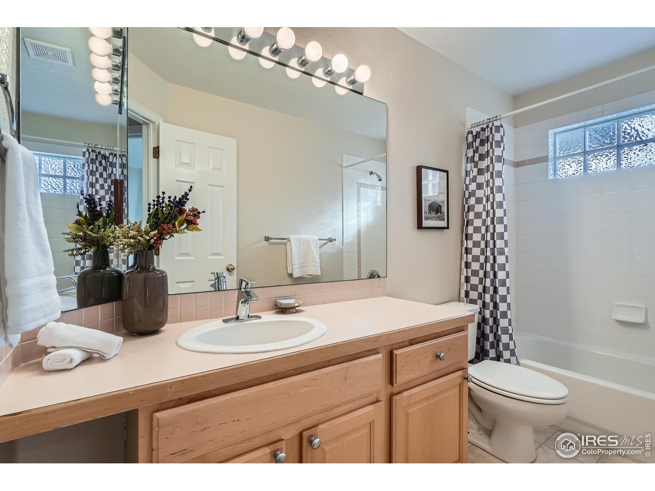 7051 Johnson Circle Niwot, CO 80503 - Photo 19 of 34 a bathroom with a sink a toilet and a mirror