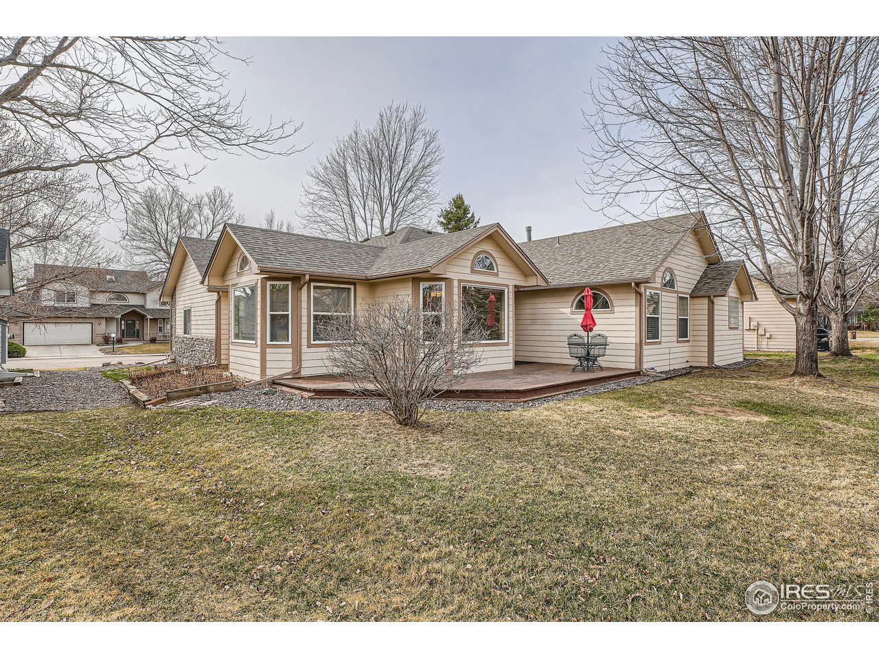 7051 Johnson Circle Niwot, CO 80503 - Photo 27 of 34 a view of a white house with a big yard and large trees