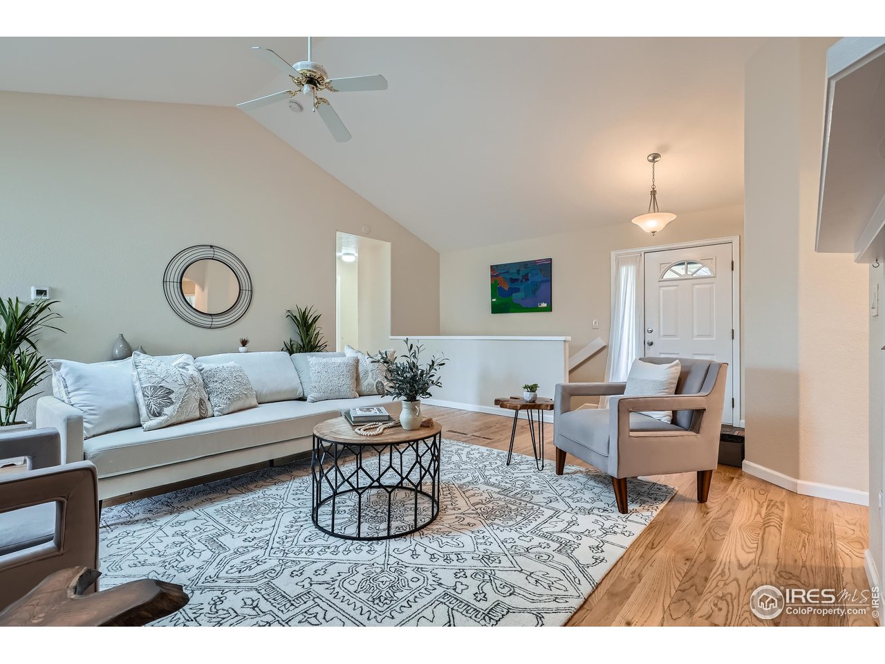 7051 Johnson Circle Niwot, CO 80503 - Photo 4 of 34 a living room with furniture and a chandelier
