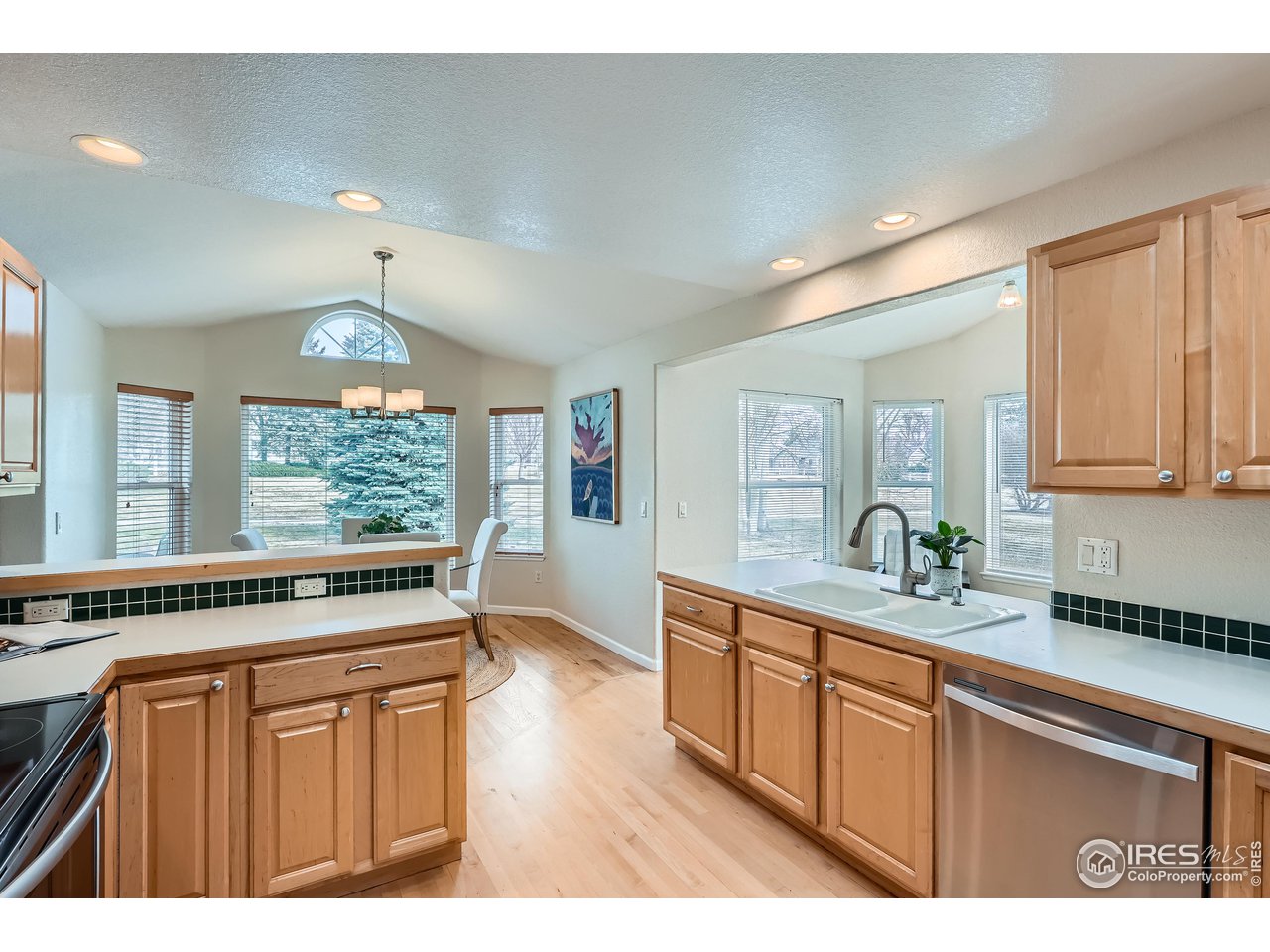 7051 Johnson Circle Niwot, CO 80503 - Photo 6 of 34 a kitchen with a sink and wooden cabinets