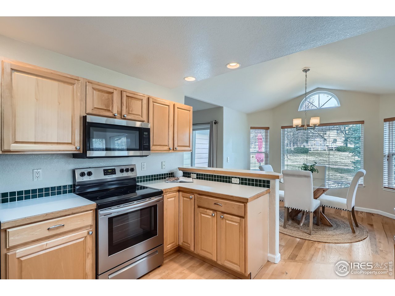 7051 Johnson Circle Niwot, CO 80503 - Photo 7 of 34 a kitchen with stainless steel appliances kitchen island granite countertop a sink and cabinets