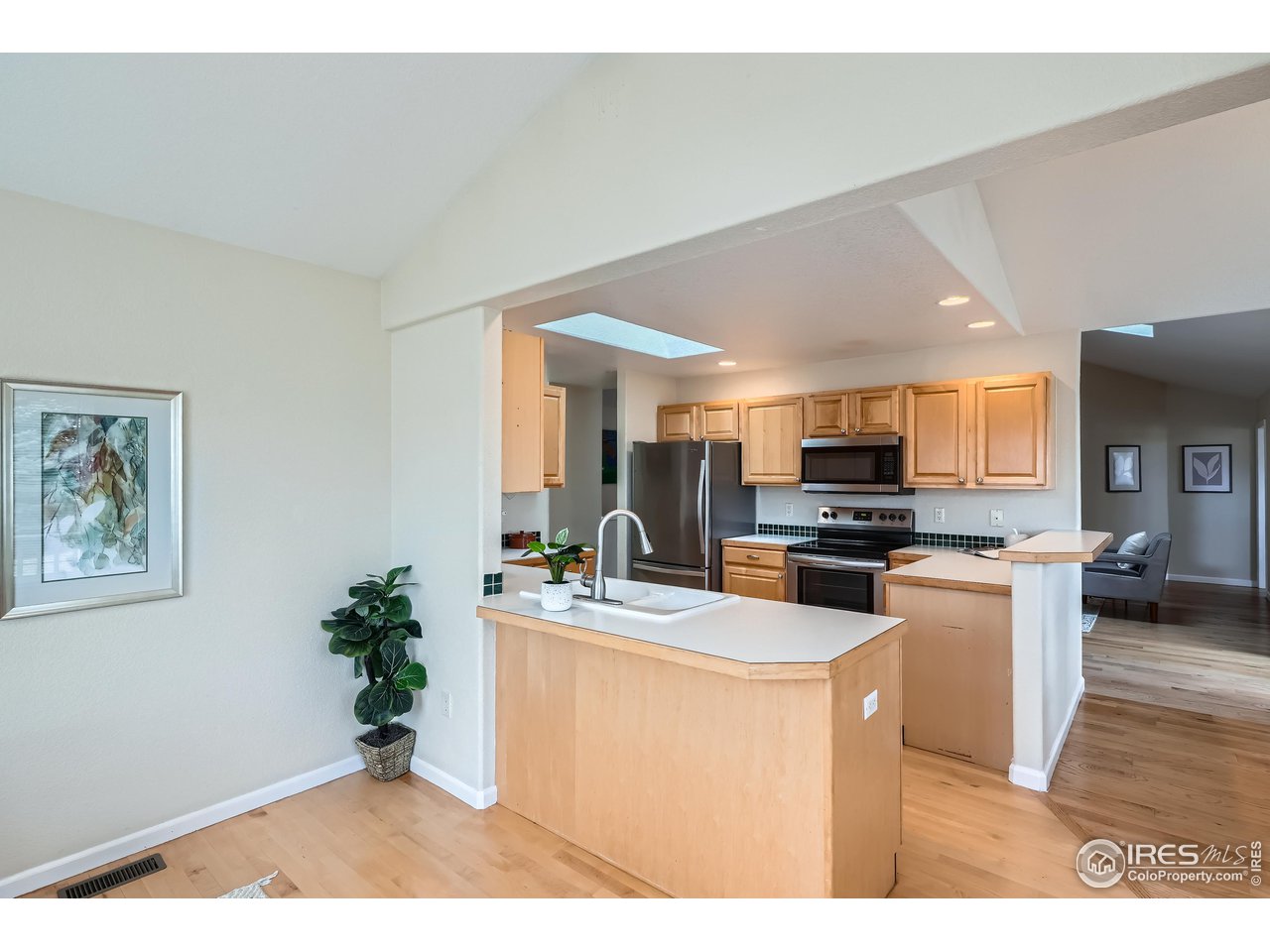 7051 Johnson Circle Niwot, CO 80503 - Photo 8 of 34 a kitchen with a refrigerator a stove a microwave a dining table and chairs