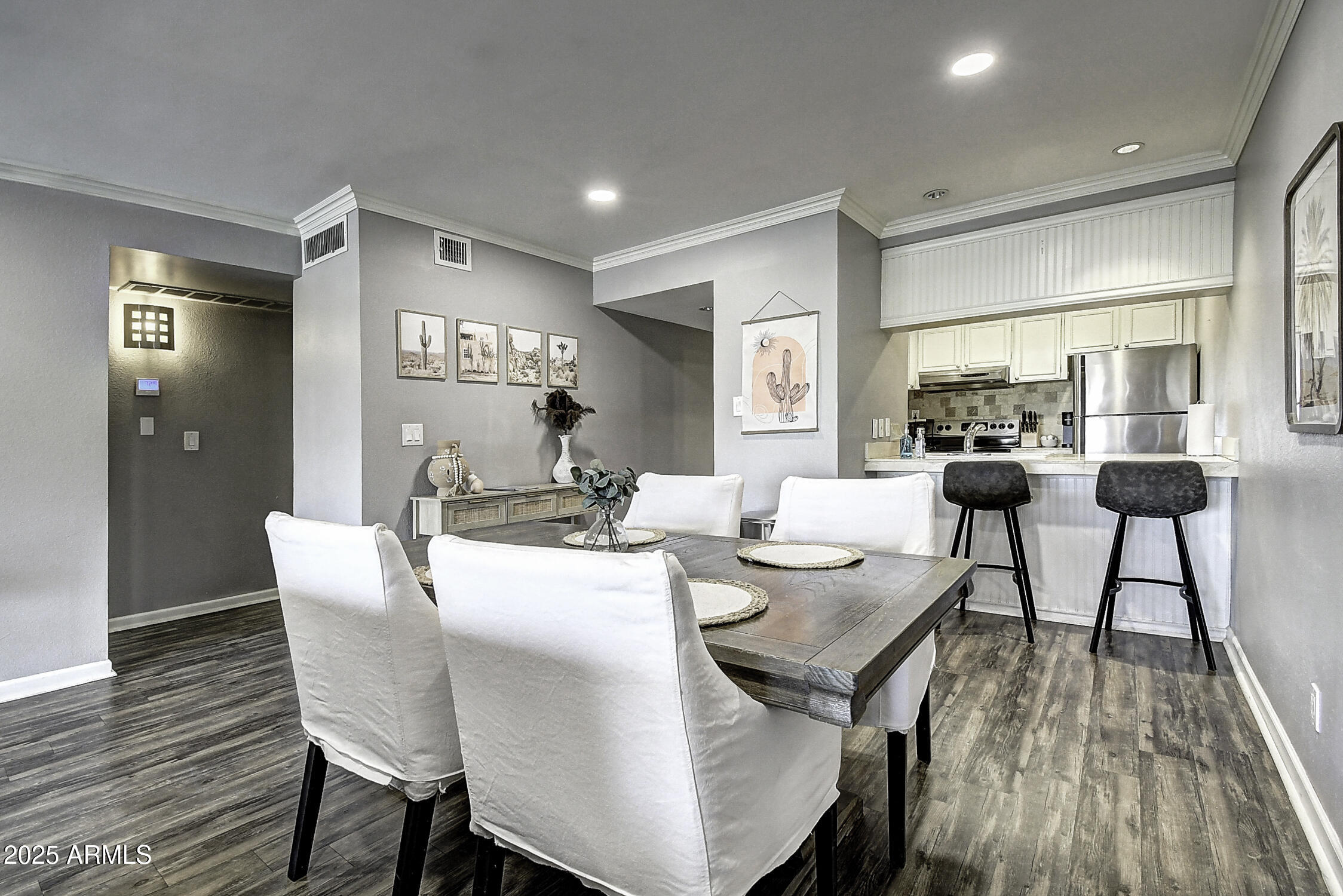 7625 East Camelback Road, Unit B203 Scottsdale, AZ 85251 - Photo 13 of 29 a view of a dining room with furniture and wooden floor