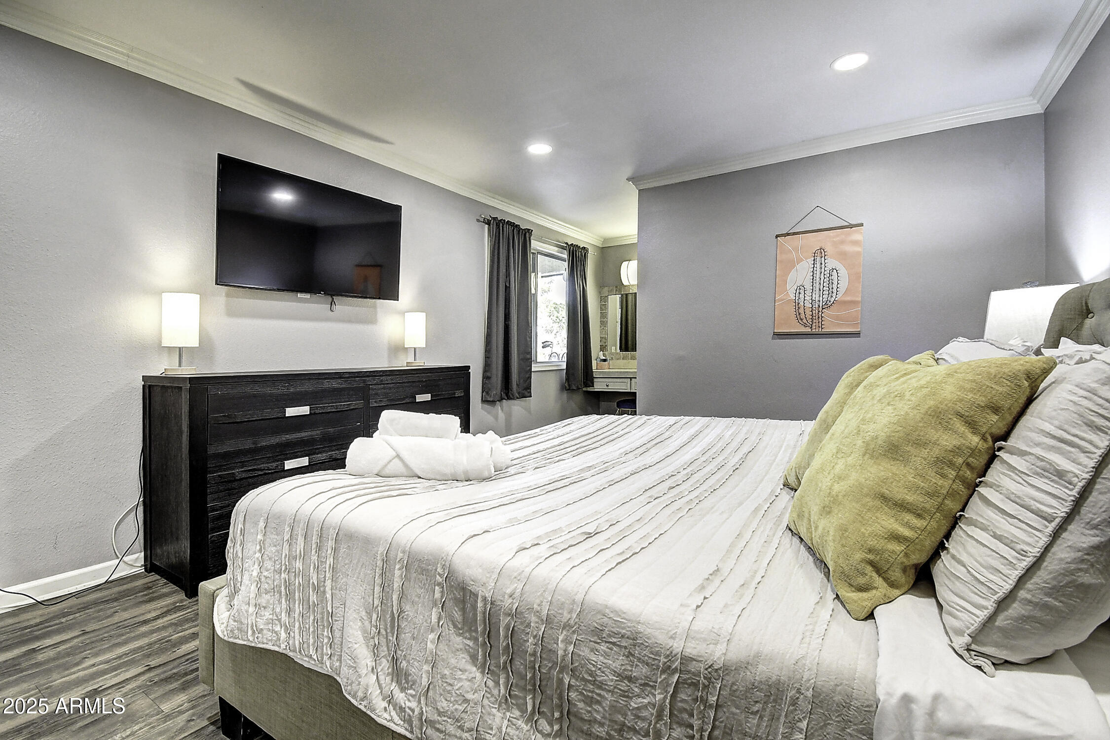 7625 East Camelback Road, Unit B203 Scottsdale, AZ 85251 - Photo 20 of 29 a bedroom with a bed and a flat screen tv