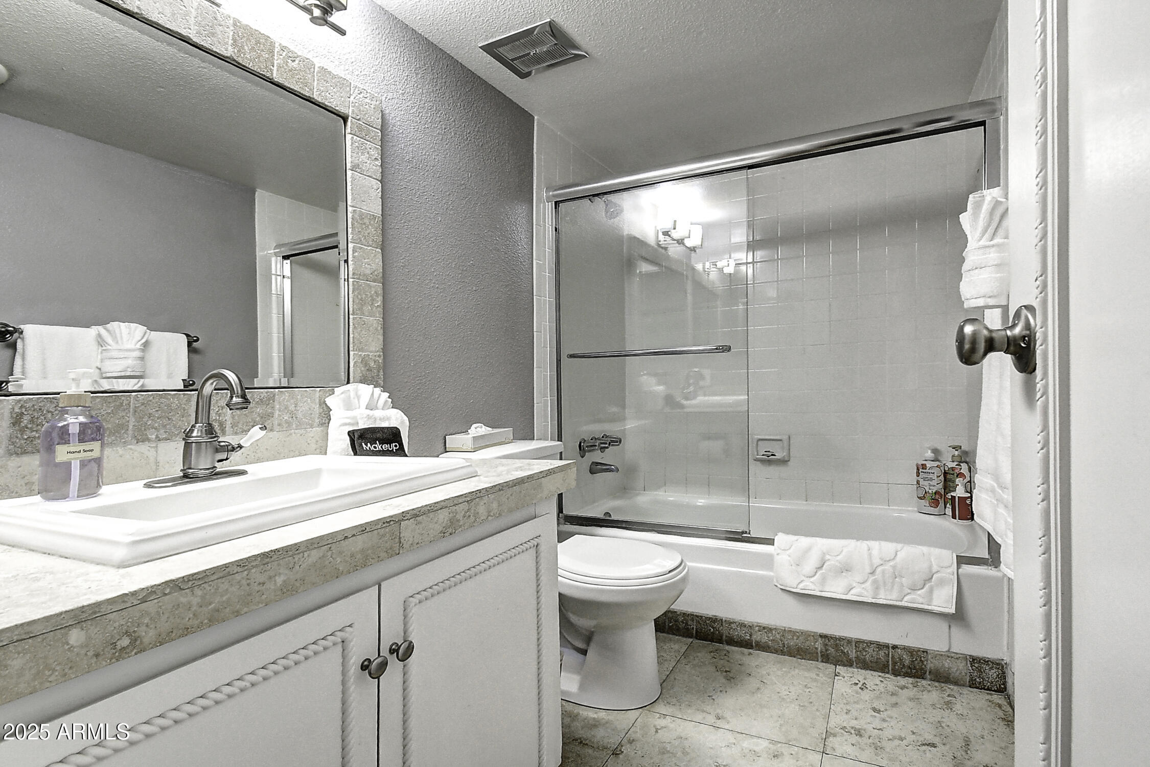 7625 East Camelback Road, Unit B203 Scottsdale, AZ 85251 - Photo 23 of 29 a bathroom with a double vanity sink toilet mirror and bathtub
