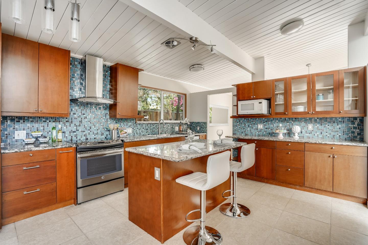 1401 South Wolfe Road Sunnyvale, CA 94087 - Photo 29 of 67 a kitchen with stainless steel appliances granite countertop a stove a sink and a microwave