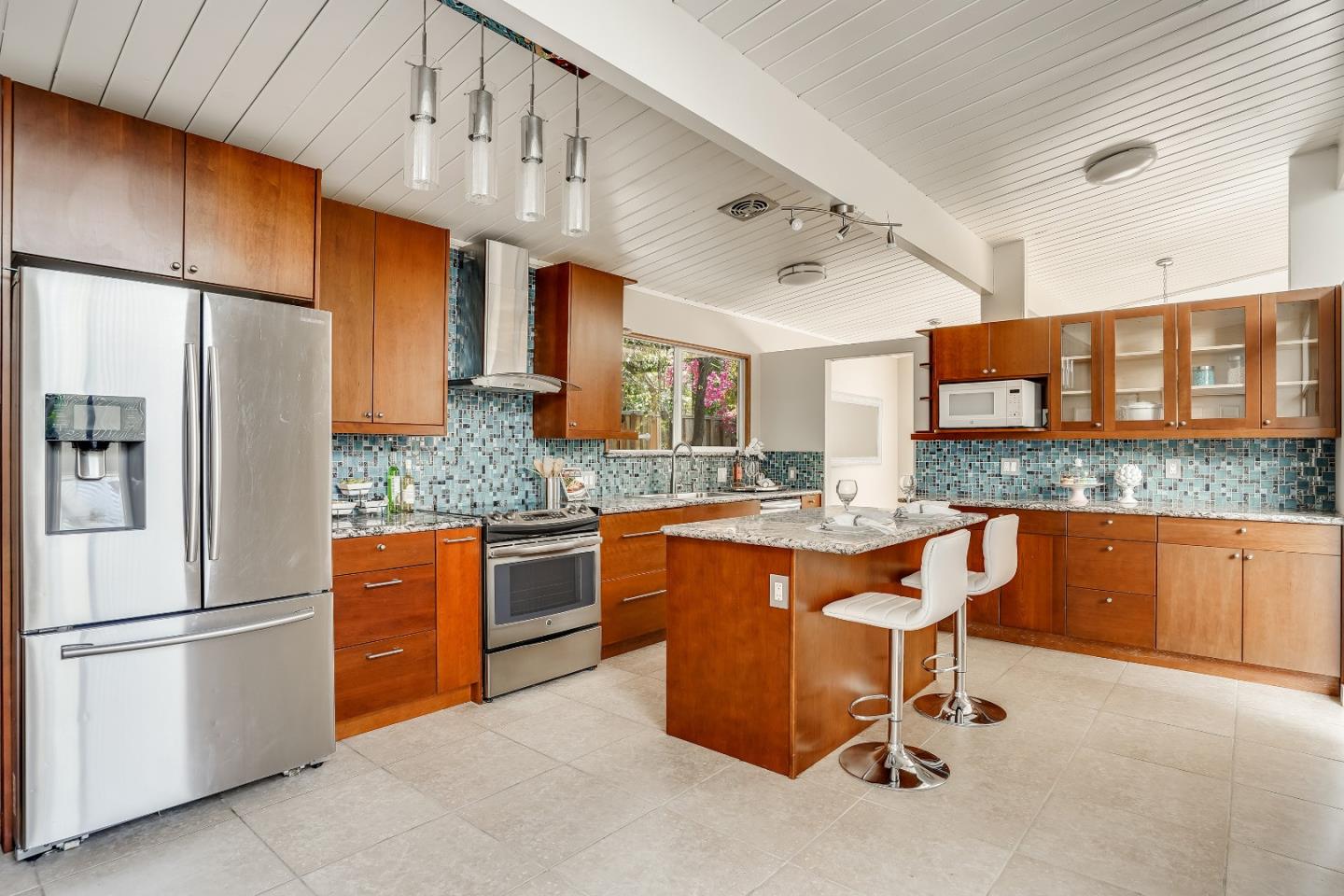 1401 South Wolfe Road Sunnyvale, CA 94087 - Photo 30 of 67 a kitchen with stainless steel appliances granite countertop a refrigerator a sink dishwasher a dining table and chairs with wooden cabinets