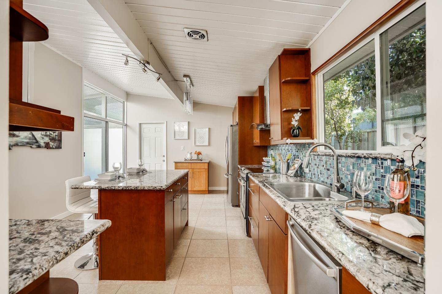 1401 South Wolfe Road Sunnyvale, CA 94087 - Photo 32 of 67 a kitchen with stainless steel appliances granite countertop a sink stove and cabinets