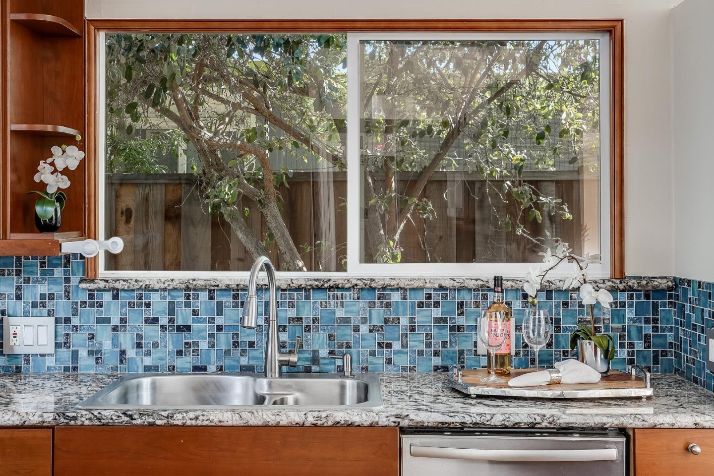 1401 South Wolfe Road Sunnyvale, CA 94087 - Photo 34 of 67 a bathroom with a granite countertop sink and a large mirror next to a window