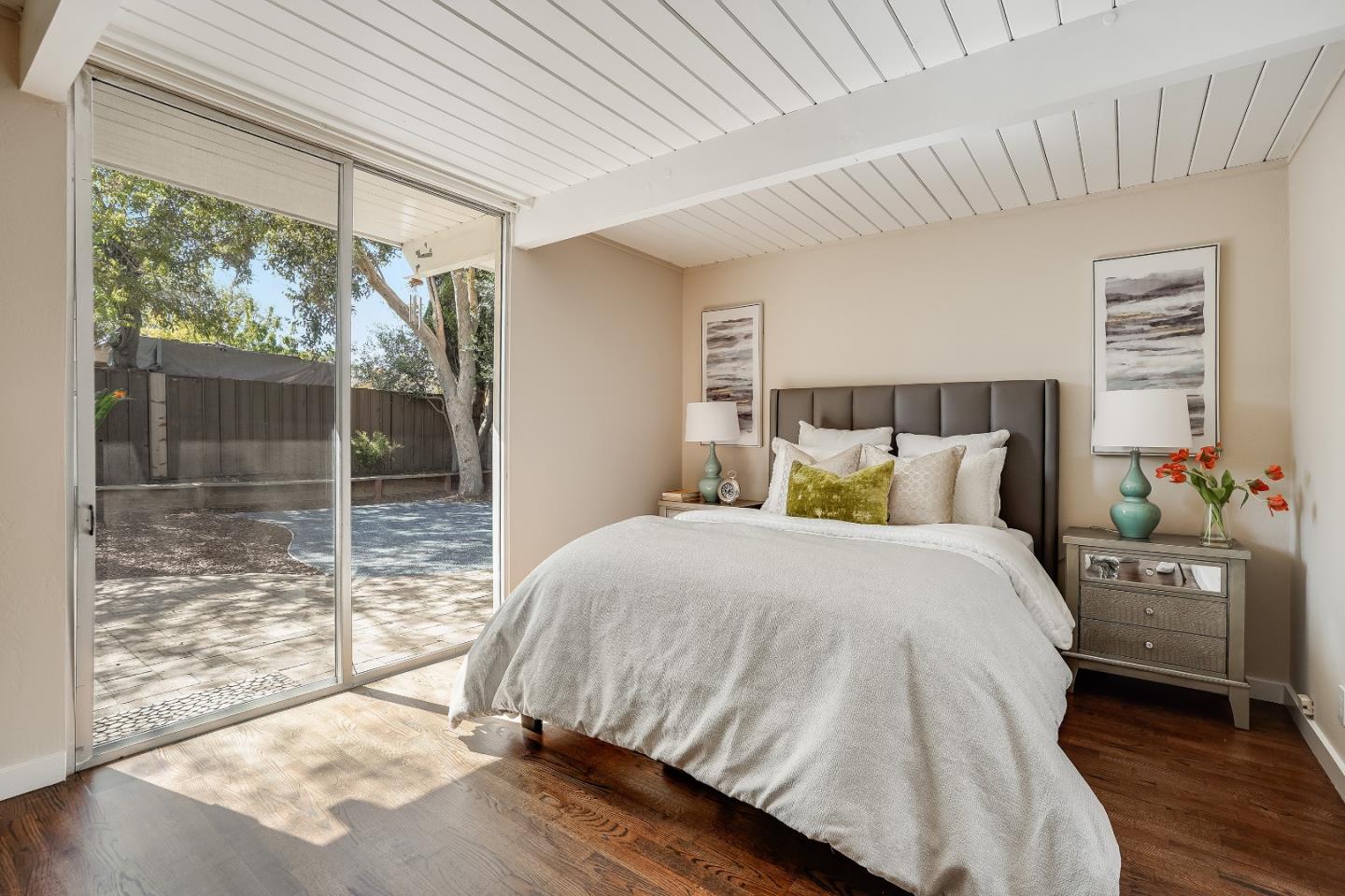 1401 South Wolfe Road Sunnyvale, CA 94087 - Photo 36 of 67 a bedroom with a balcony a bed and a wooden floor