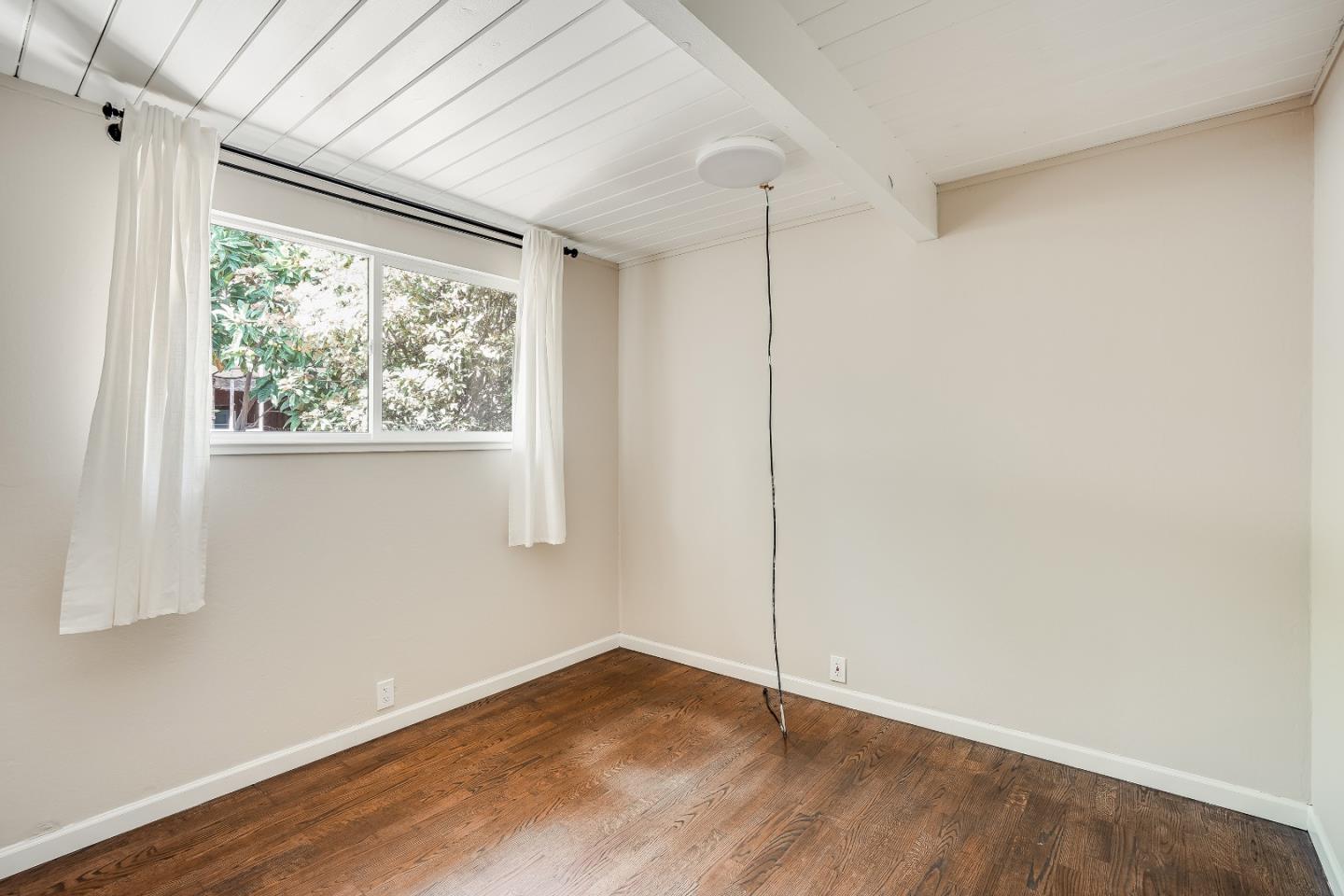 1401 South Wolfe Road Sunnyvale, CA 94087 - Photo 48 of 67 a view of an empty room with wooden floor and a window