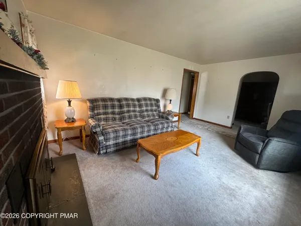 a view of living room with furniture and a rug
