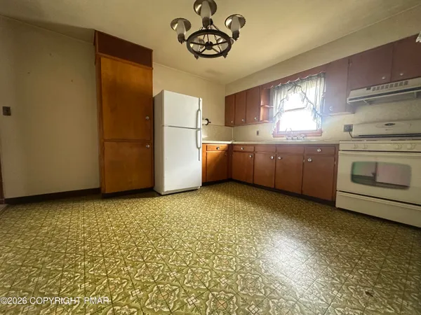 a kitchen with a refrigerator and a sink