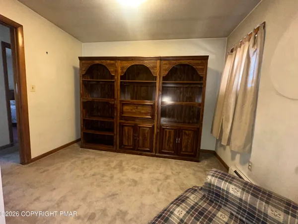 an empty room with furniture and natural light