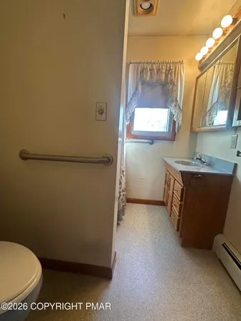 a bathroom with a sink toilet and mirror
