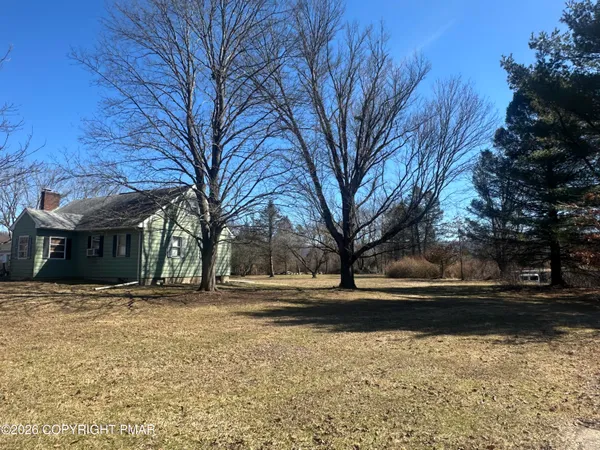 a backyard of a house with large trees