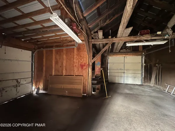 a view of empty room with wooden ceiling