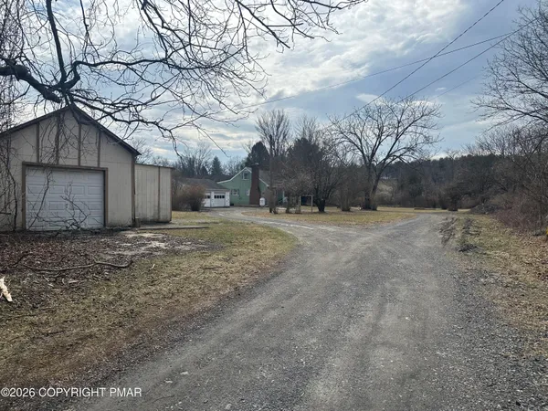 a view of a yard with a tree