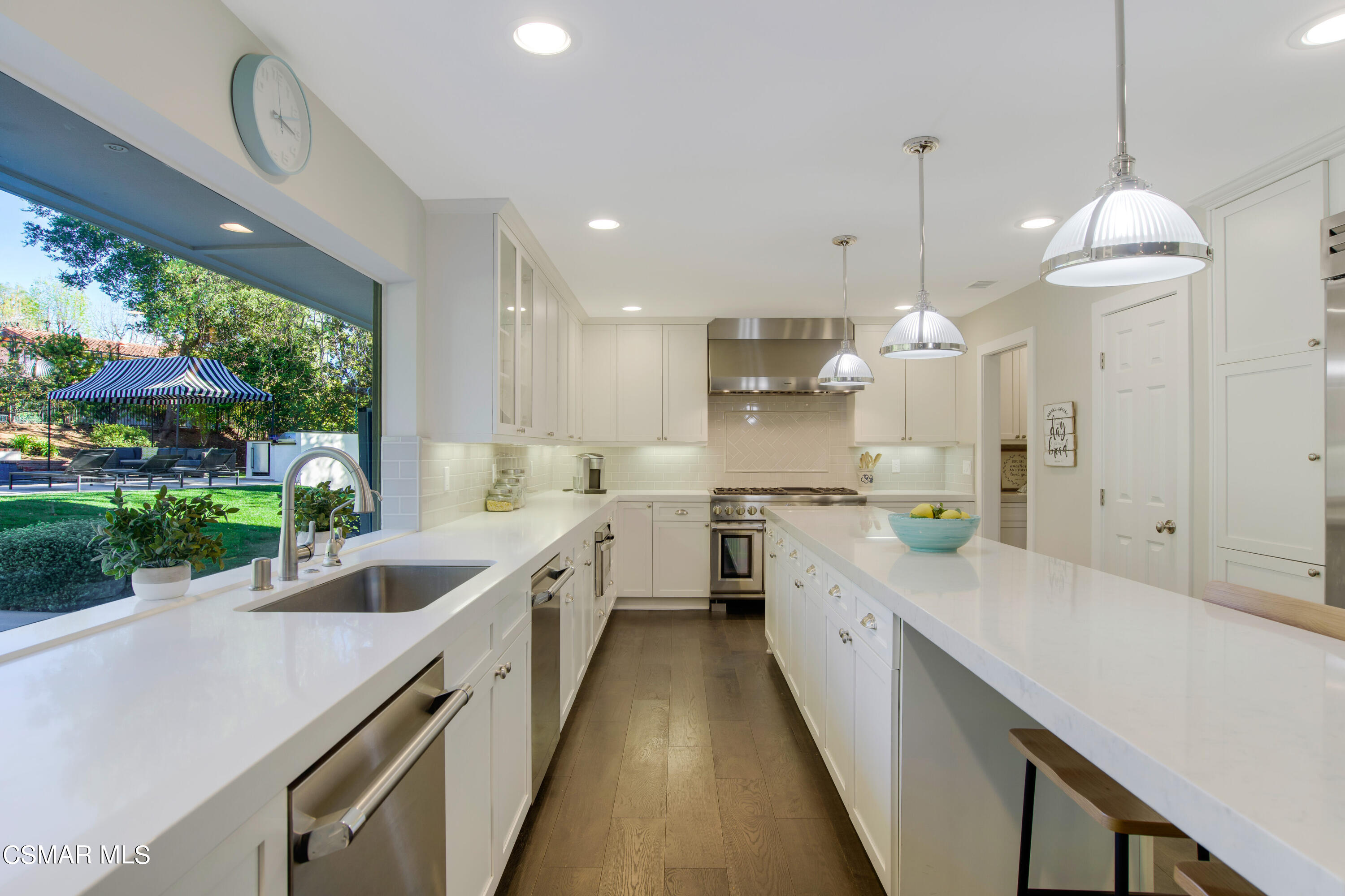 1752 Upper Ranch Road Westlake Village, CA 91362 - Photo 12 of 37 a large kitchen with kitchen island lots of counter space wooden floor and stainless steel appliances