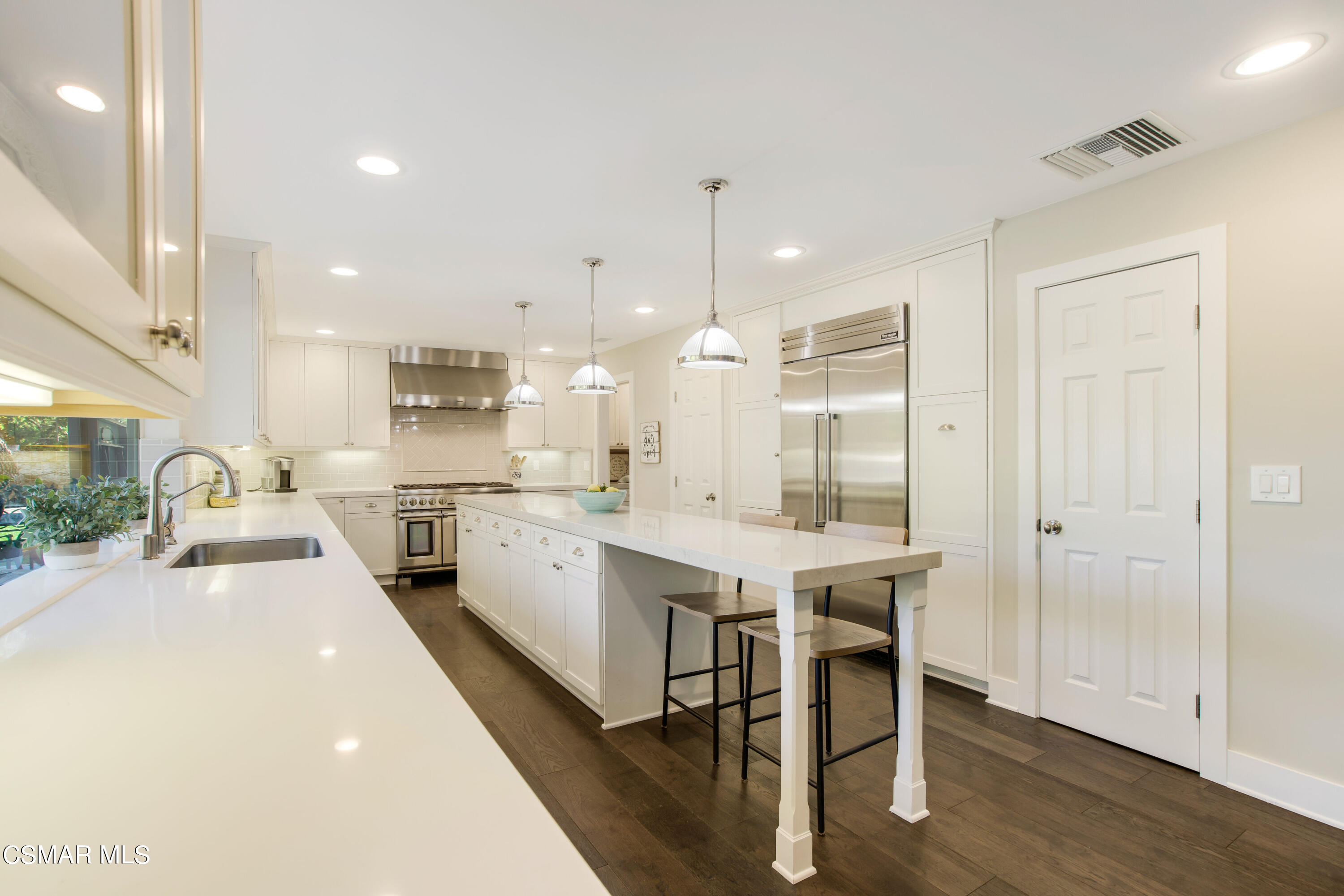 1752 Upper Ranch Road Westlake Village, CA 91362 - Photo 13 of 37 a kitchen with a sink a stove a refrigerator and white cabinets with wooden floor