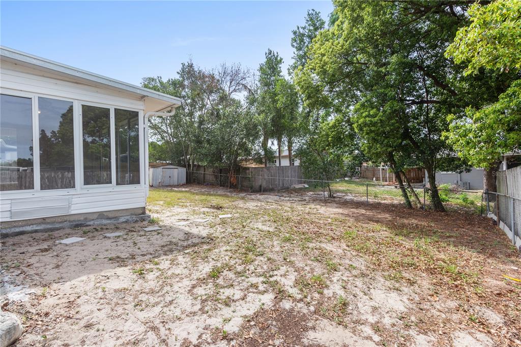 7208 Fair Oaks Street Spring Hill, FL 34606 - Photo 20 of 25 a backyard of a house with table and chairs