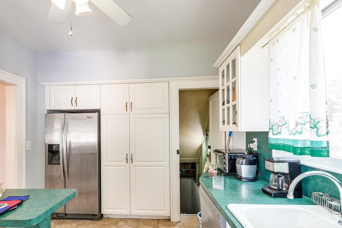 44 Freeman Street Woodbridge, NJ 07095 - Photo 2 of 8 a kitchen with sink refrigerator and microwave