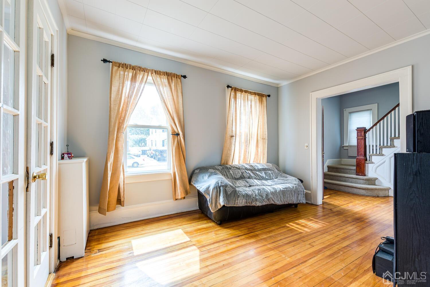44 Freeman Street Woodbridge, NJ 07095 - Photo 5 of 8 a spacious bedroom with a bed and window